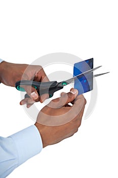 Businessman cutting credit card with scissors