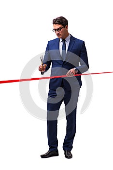 The businessman cutting red ribbon isolated on white