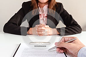 Businessman decide to sign insurance package with businesswoman