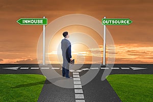 Businessman deciding between outsourcing and inhouse