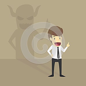 Businessman With Demon Shadow Wall Behind