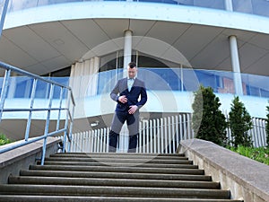 A Businessman descends stairs gracefully in sharp attire Each step showcases the Businessman's poise. Background photo