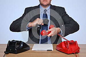 Businessman at desk on a conference call.