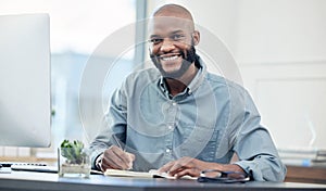 Businessman, desk and notebook in portrait with smile in office with planning for creative project. Accountant, auditor