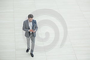 Businessman dialing the number on the smartphone