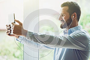 Businessman with digital tablet and earphones