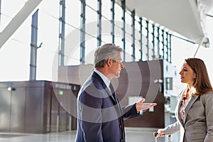 Businessman discussing plans with business partner in airport