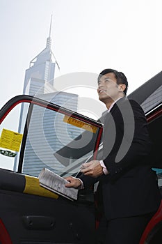 Businessman Disembarking From Cab