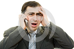 Businessman in distress speaks by phone