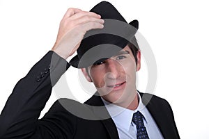 Businessman doffing his hat
