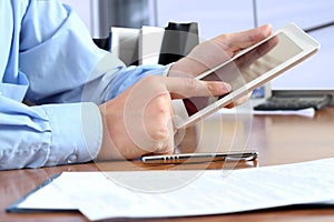 Businessman doing business, sitting at his desk in the office,