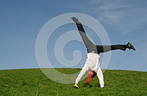 Businessman doing cartwheel photo