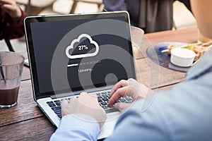 Businessman doing cloud uploading using laptop / computer