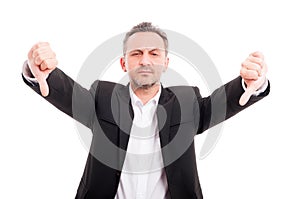 Businessman doing double thumb down gesture