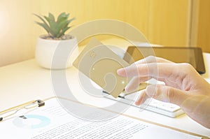 Businessman doing online banking, making a payment or purchasing goods on the internet entering his credit card details on a
