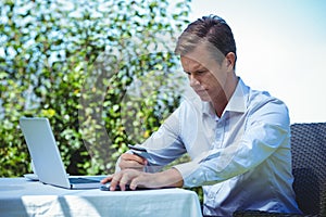 Businessman doing online shopping with laptop and credit card