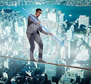 Businessman doing tightrope walking in risk concept