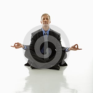 Businessman doing yoga.