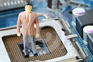 Businessman doll Stand on a computer motherboard.