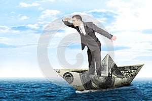 Businessman in dollar boat