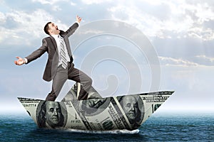 Businessman in dollar boat