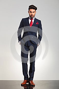 Businessman in double breasted suit standing with hands in pock