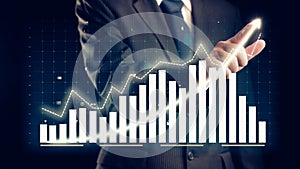 Businessman draw finance allusive graph chart showing business profit growth