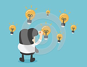 Businessman draw on virtual screen with idea light bulb icons fl