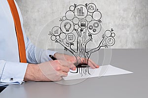 Businessman drawing business tree
