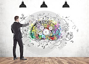 Businessman drawing cog brain