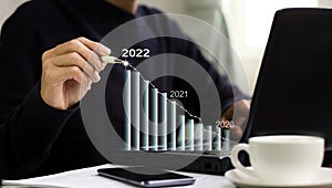 Businessman drawing graph growth to planning sale marketing target and financial business in 2022