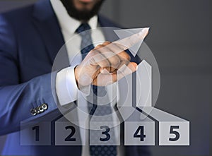 Businessman drawing growth 3D diagram with finger