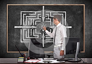 Businessman drawing labyrinth