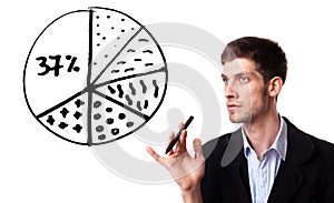 Businessman drawing pie chart in whiteboard