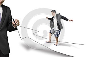Businessman drawing road with growth arrow the other surfing tow