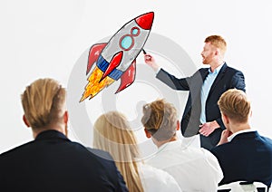 Businessman drawing a rocket during a training meeting. Concept of business improvement and enterprise startup