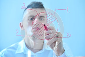 Businessman drawing stock pie chart on transparent screen