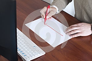 Businessman draws a graph on a blank sheet. Red arrow