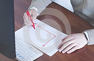 Businessman draws a graph on a blank sheet. Red arrow