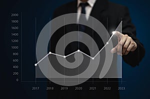 Businessman draws increase graph corporate future