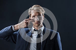 Businessman draws two stripes on his cheeks, war paint. Competition in business, concept.