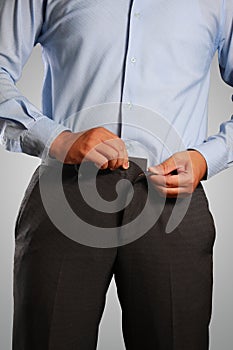 Businessman Dressing, Pulling His Pants Placket