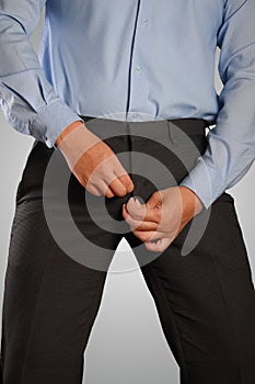 Businessman Dressing, Pulling His Pants Zipper