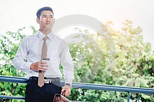 Businessman drinking a coffee and looking view and thinking succ