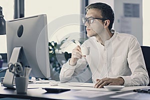 Businessman drinking coffee and smiling