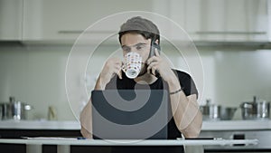 Businessman drinking coffee and talking phone at home. Business man call mobile