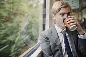 Businessman Drinking Coffee on the Train