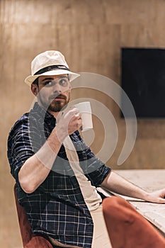 Businessman drinking coffee at a work meeting in the office. Lifestyle concept