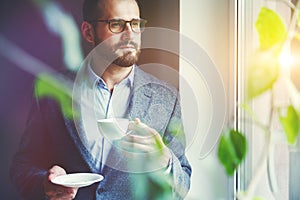 Businessman drinking morning coffee at office