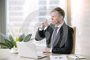 Businessman drinking water